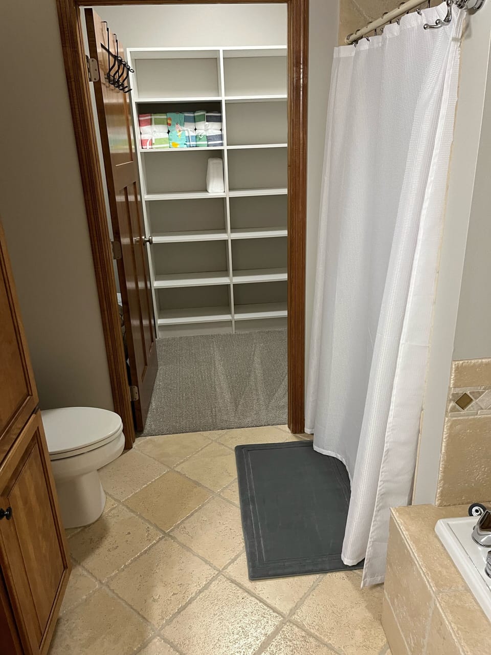 MBR bathroom with dual vanities, jet tub, separate shower, and walk-in closet