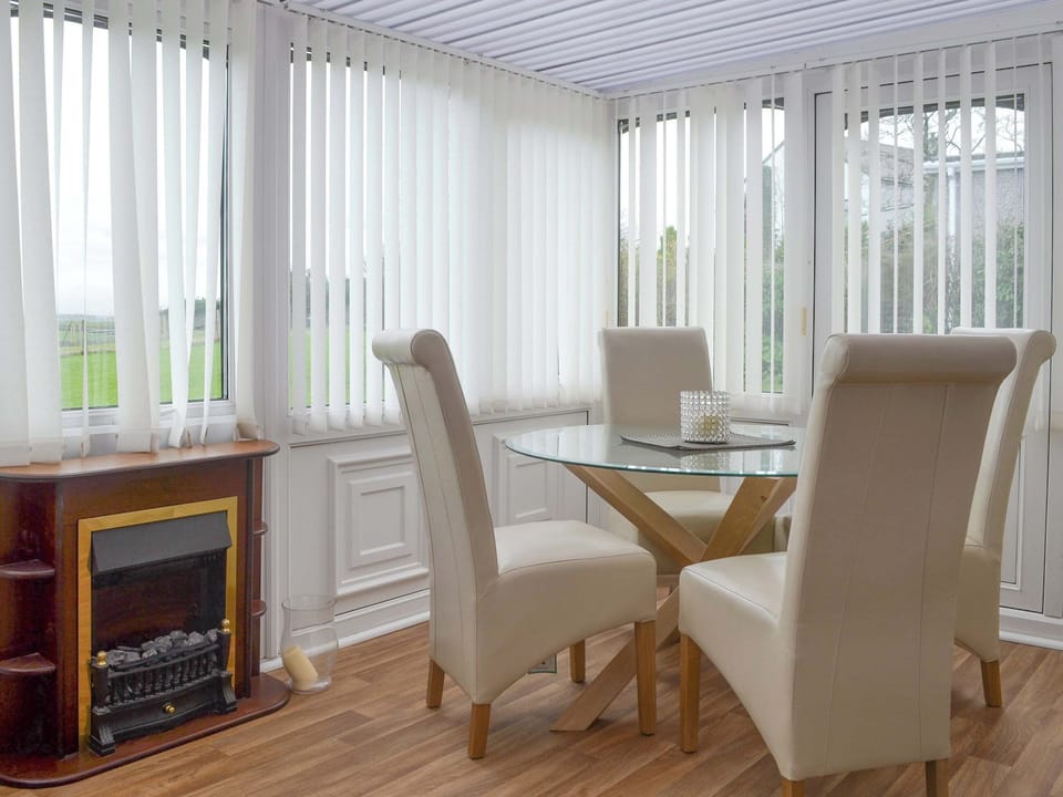 Delightful dining area within conservatory | Pen Parc, Rhosybol, near Amlwch
