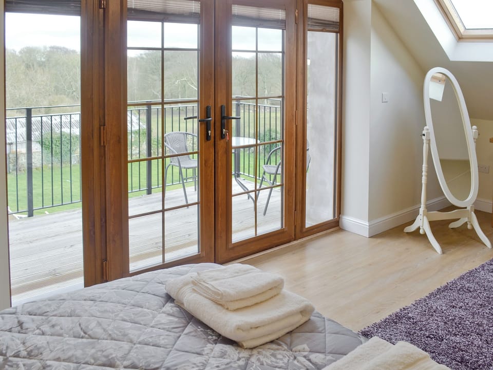 French doors from double room to balcony | Rhiwal Kitty - Trehwfa Cottages, Bodedern, near Holyhead