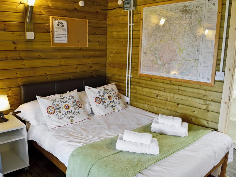 Comfortable sleeping area with double bed | Kestrel Cabin - Wallace Lane Farm Cottages, Brocklebank, near Caldbeck and Uldale