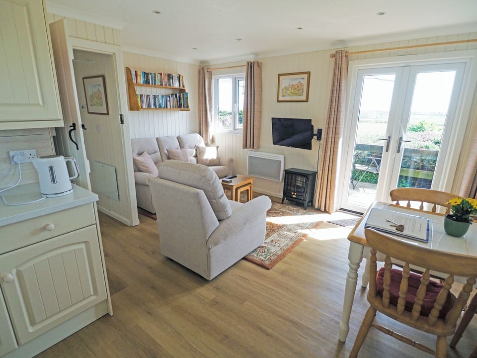 Cosy and comfortable living area with double doors to the terrace | Ash Lodge, Nawton, near Helmsley
