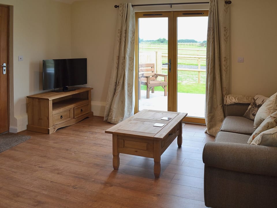 Comfortable seating with French doors to patio | Saddlers Cottage - Old Chalksole Cottages, Alkham, near Dover