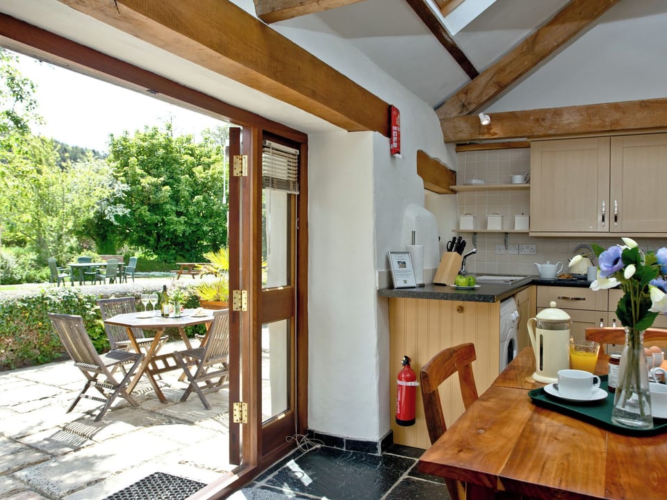 Open-plan living space with French doors to patio | The Smithy - Park Mill Farm, Chulmleigh