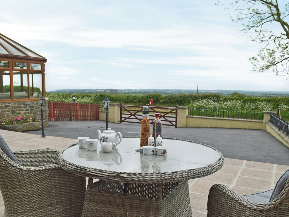 Relaxing sitting-out-area with lovely views | Hayloft Cottage - Croft Farm Cottages, Ludchurch, near Narberth
