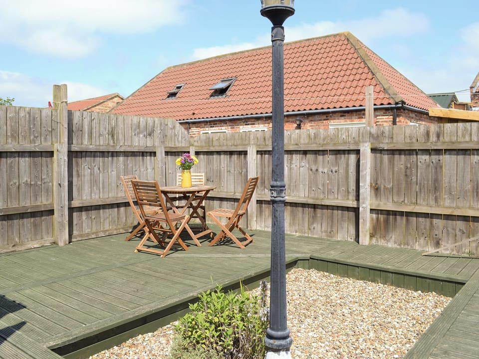 Decked area of garden with outdoor furniture | Meadow View - Struncheon Hill Farm, Brandesburton, near Bridlington