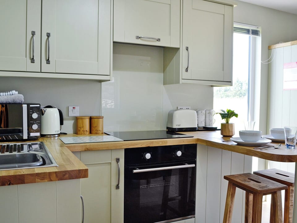 Light and airy kitchen area with with breakfast bar | The Wee Cabin - Boreland Farm Cottages, Kirkmichael, near Blairgowrie
