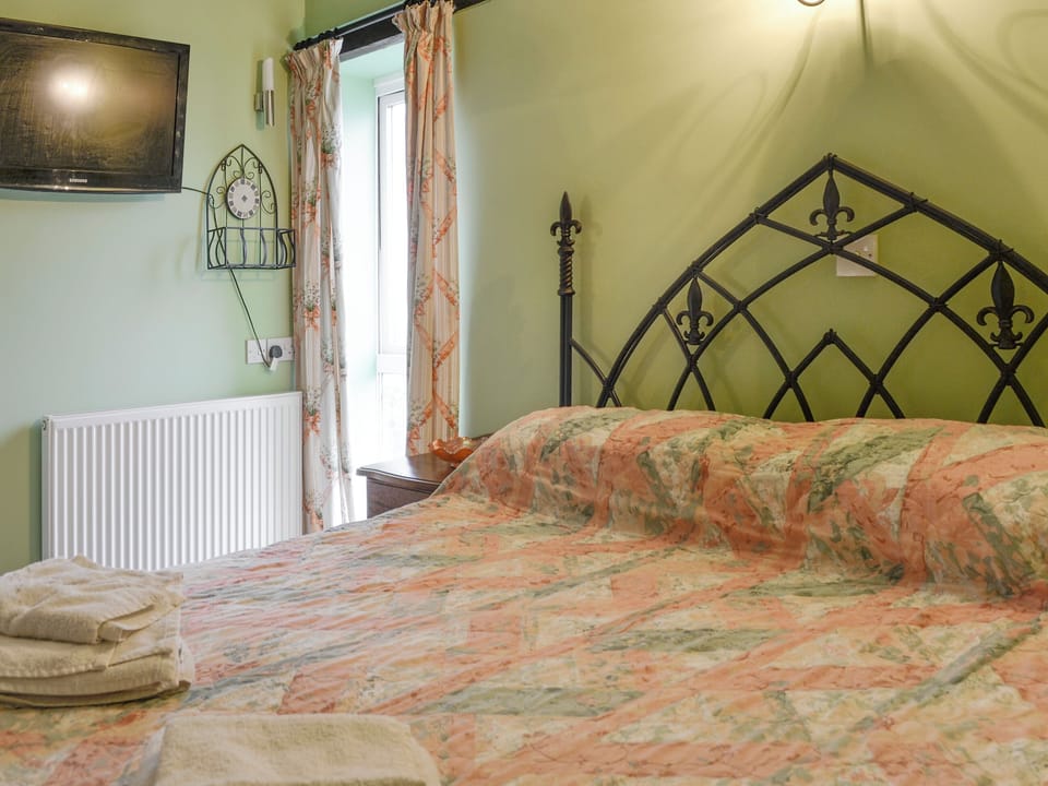 Wall-mounted TV in double bedroom | Wheelwrights - Friars Cottages, Kentisbury Ford, near Barnstaple