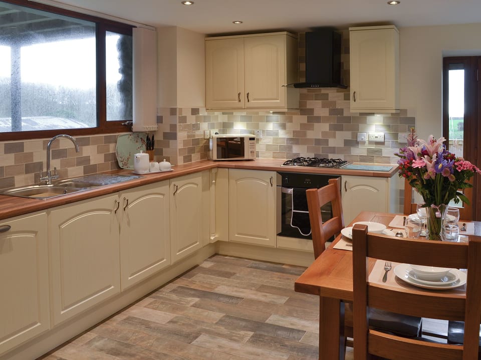 Well equipped kitchen and dining area | Stabal Arthur - Trehwfa Cottages, Bodedern, near Holyhead