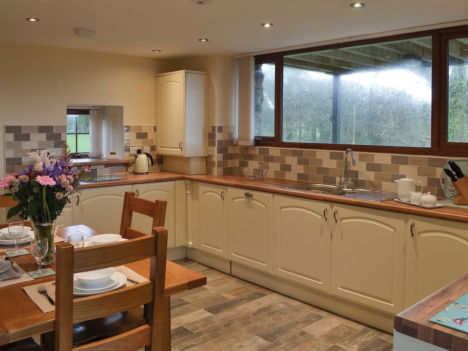 Well equipped kitchen and dining area | Stabal Arthur - Trehwfa Cottages, Bodedern, near Holyhead