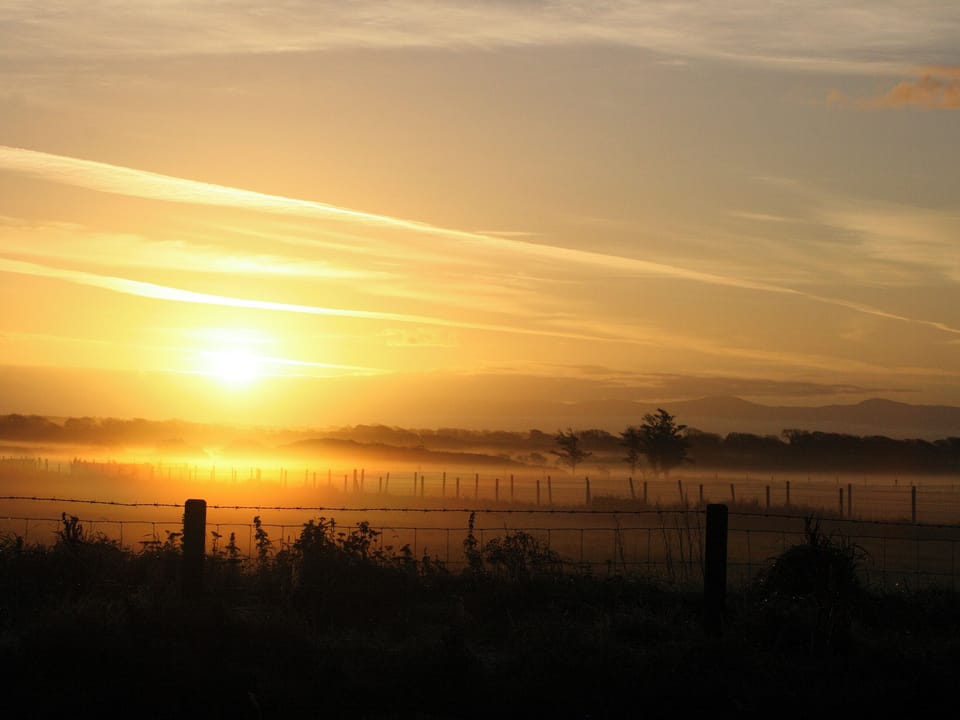 Sunrise over the meadow at Cerrig Cottages | Lapwing Cottage, Curlew Cottage - Cerrig Cottages, Caergeiliog, near Rhosneigr