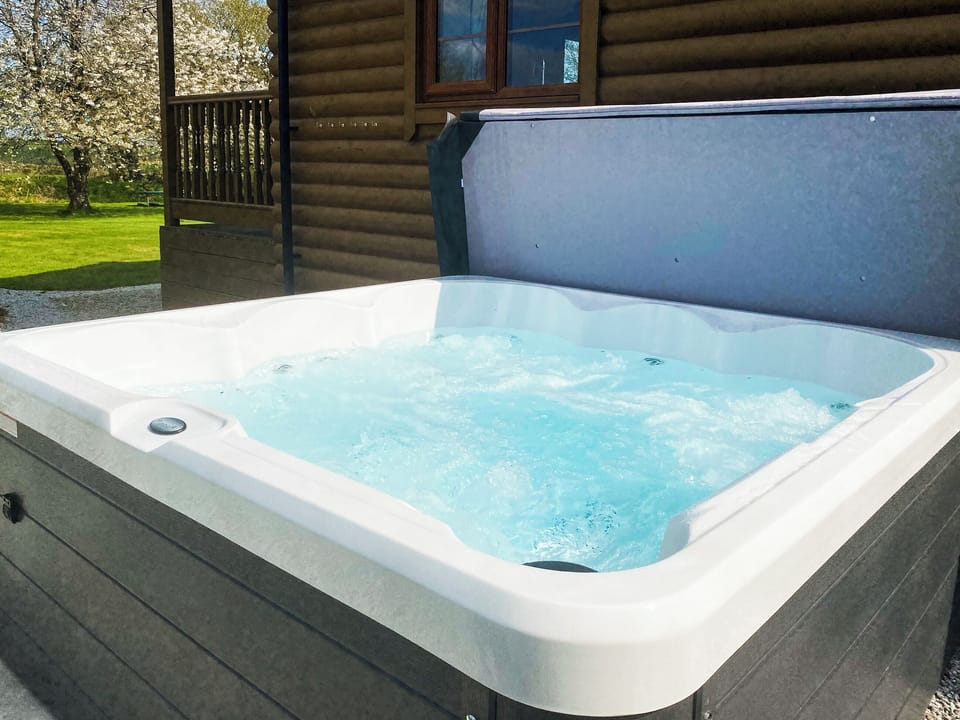 Hot tub | Tarka&rsquo;s Holt Log Cabin - Stowford Lodge Holiday Cottages, Langtree, near Great Torrington