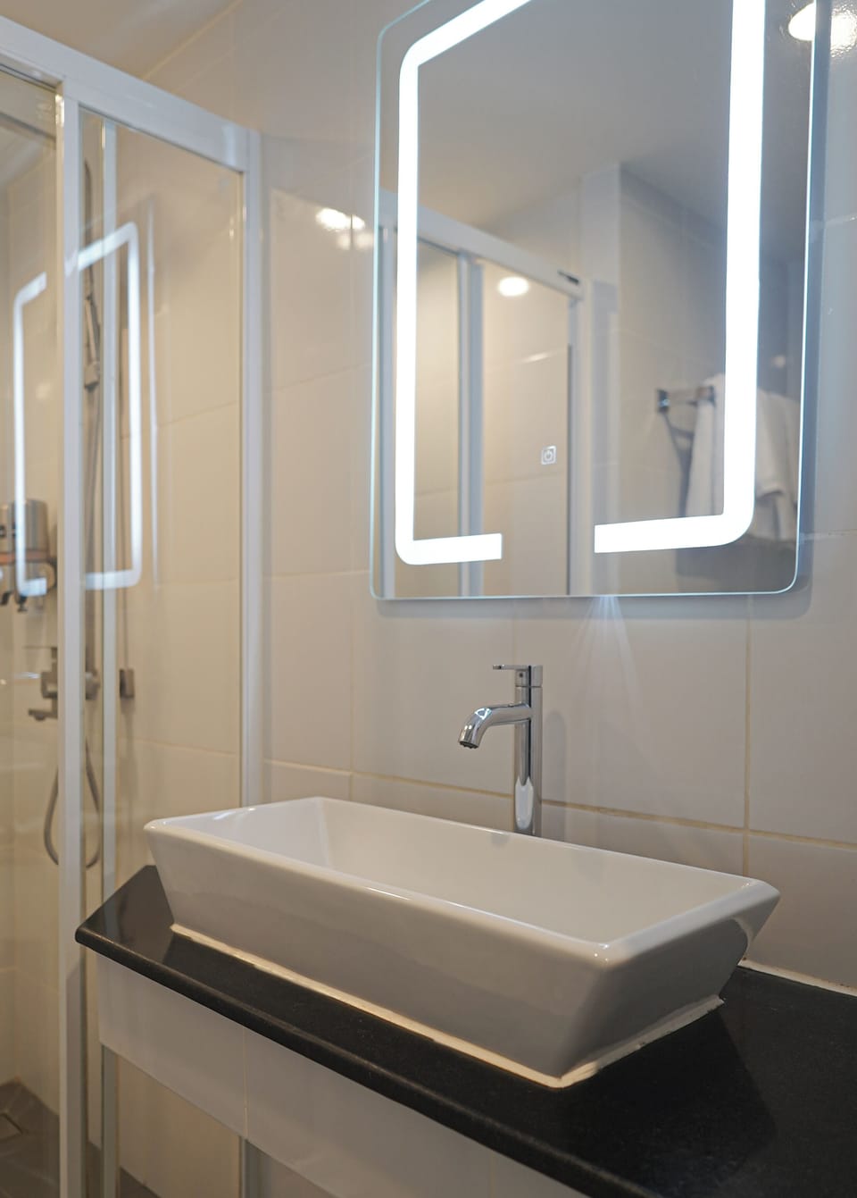 Shower, rainfall showerhead, hair dryer, towels