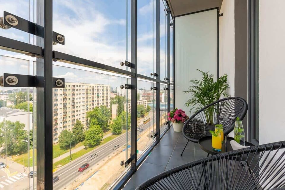 The balcony's stylish design complements the apartment's decor. 