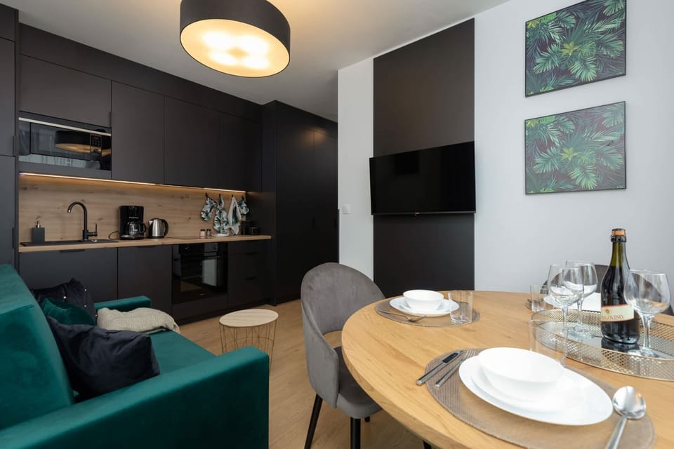 Another angle of the combined living and dining space, highlighting the open-plan layout, light flooring, and natural light.