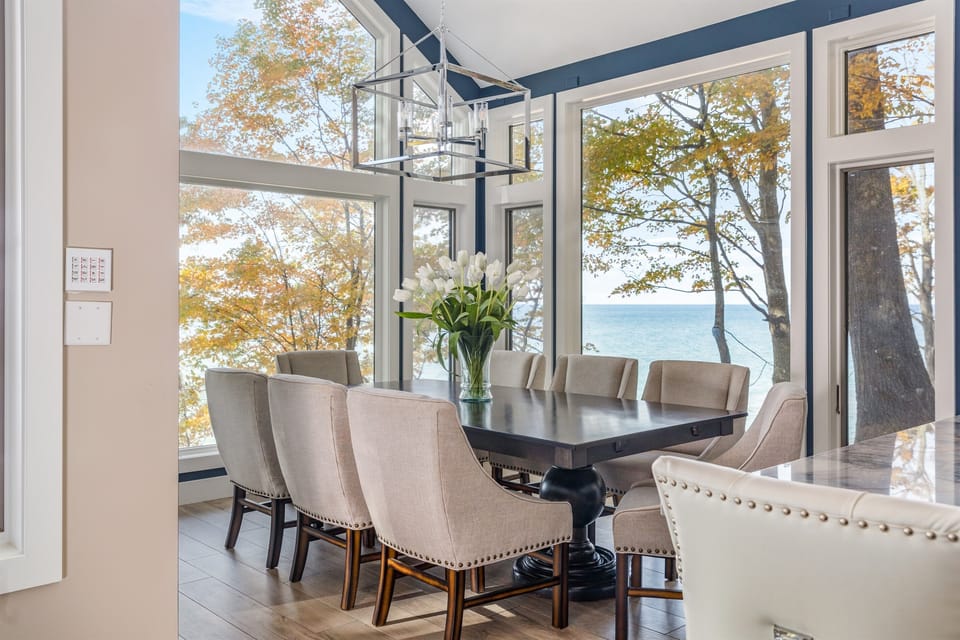 Eat-in area around the kitchen island offers a delightful view of the beautiful natural surroundings.