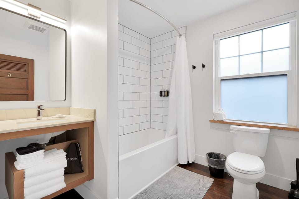 Beautiful new tile shower with modern bathtub for soaking after a day of exploring