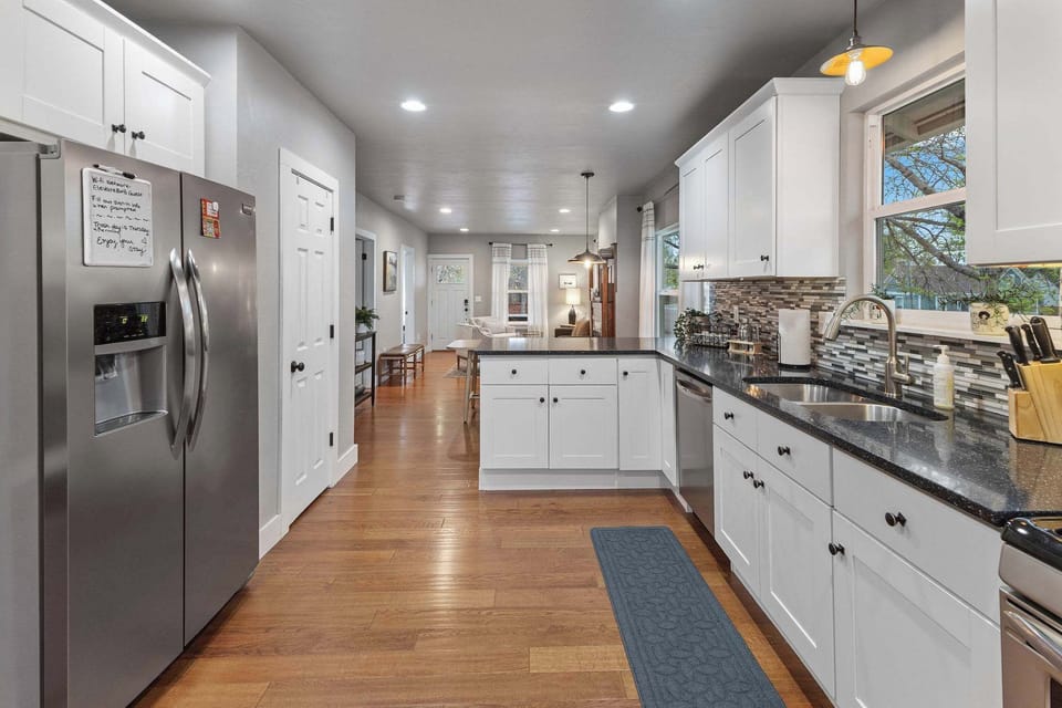 The kitchen is just past the dining table.