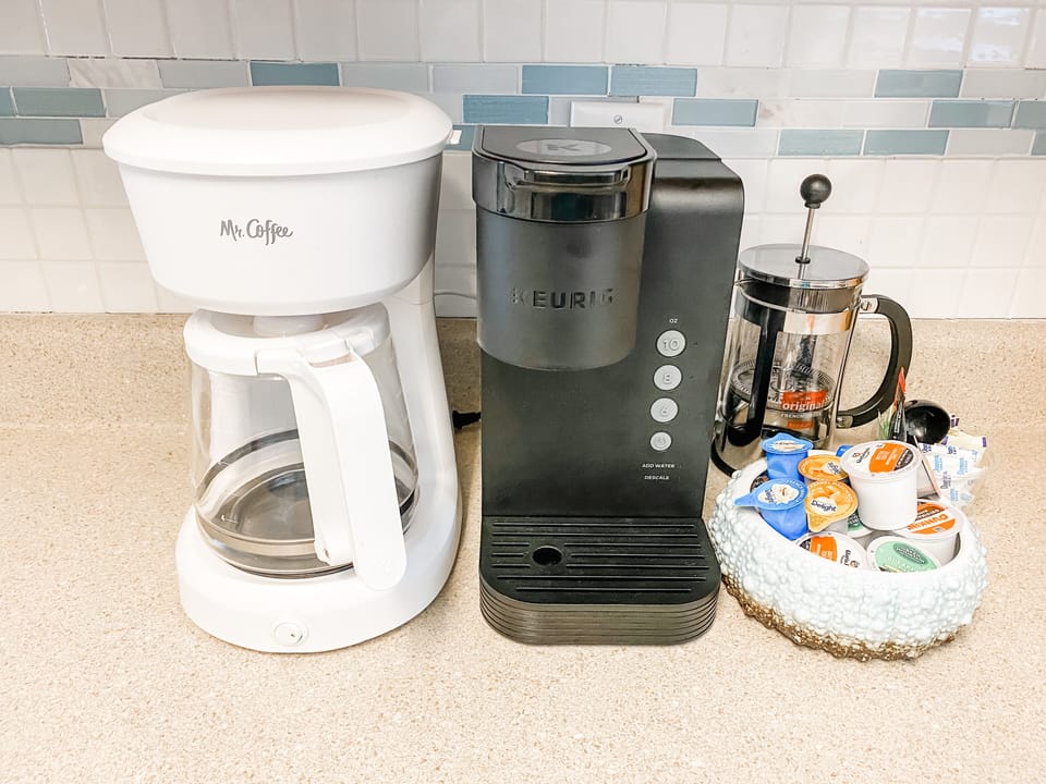 Coffee bar in kitchen features drip coffee maker, keurig, and french press