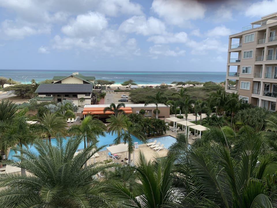 View from balcony, overlooking pool and the Caribbean Sea