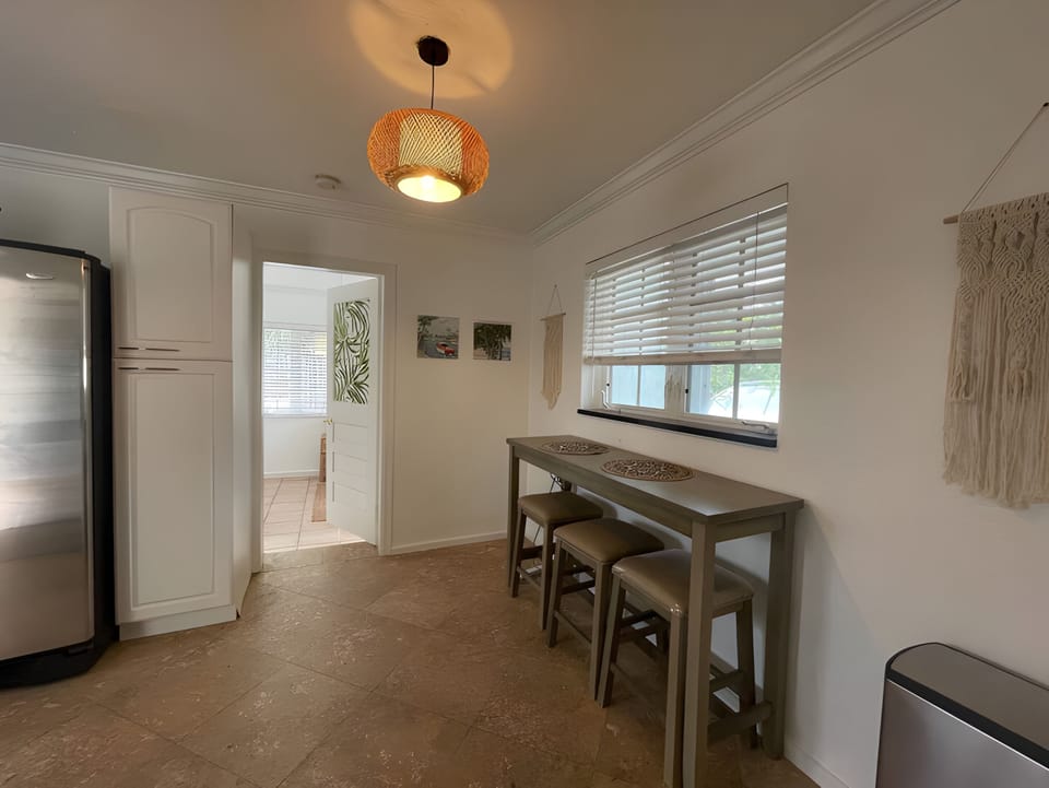 Additional breakfast bar seating is located in the kitchen.