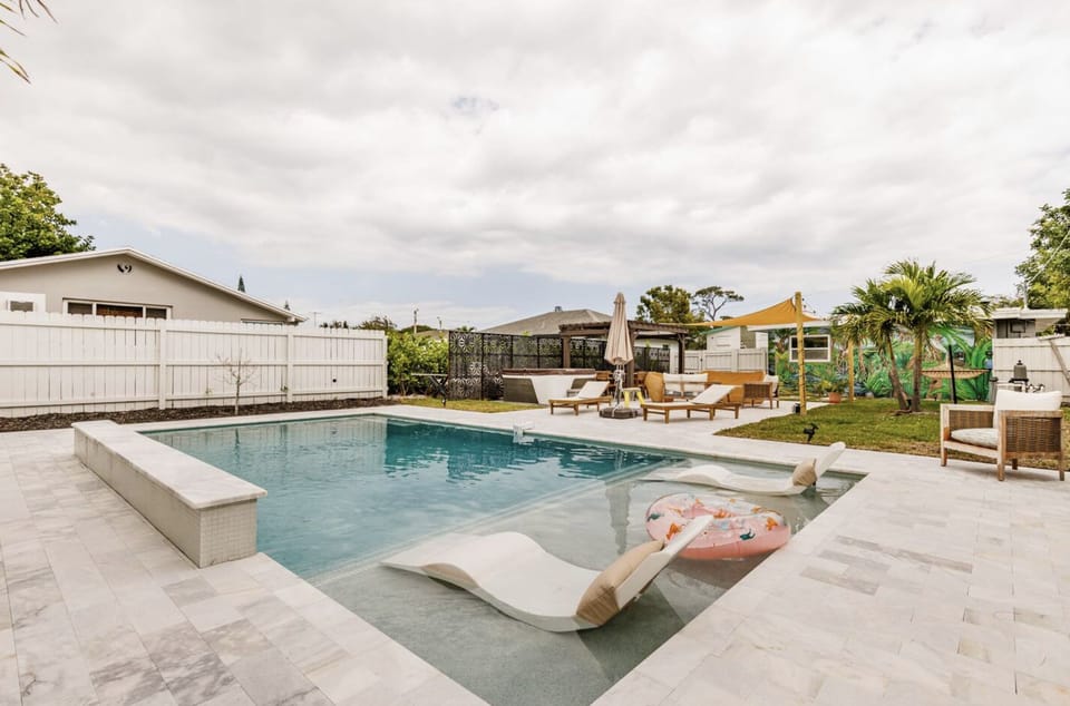 Completed in 2023, our oversized luxury pool comes with fountains, a waterfall and a unique, custom tropical mural on the back of the house. Enjoy this sliver of backyard paradise!