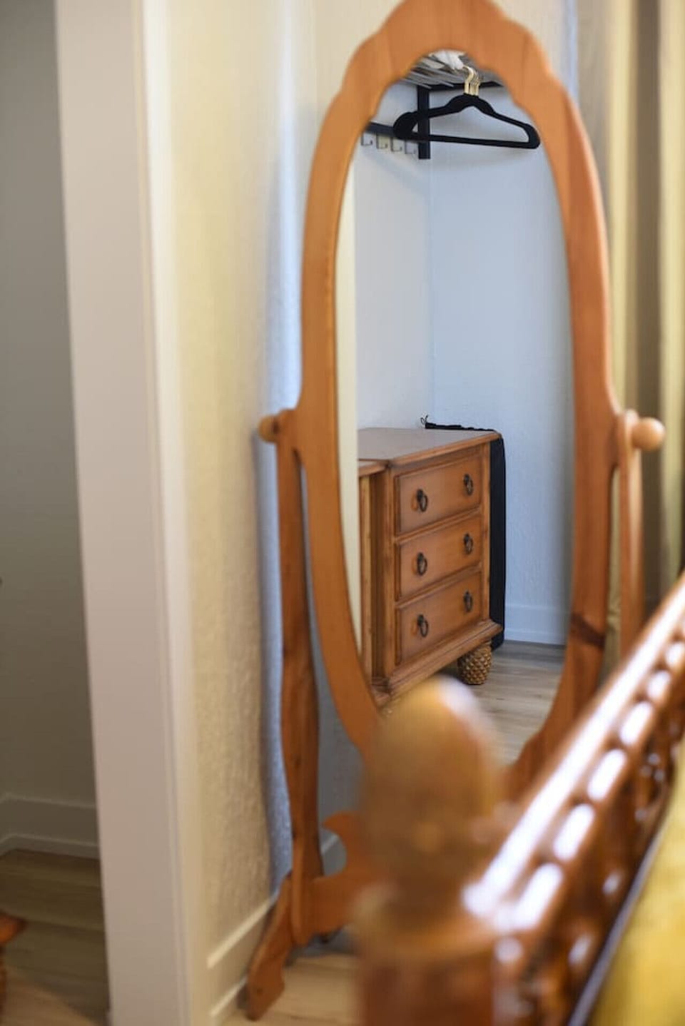 Second bedroom is equipped with a standing mirrior. The closet nook has two nightstands for clothes storage along with an overhead rack to place or hang your personal items.