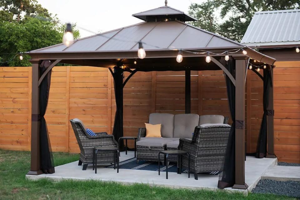 Fully-enclosed backyard with 8 foot stained wood privacy fence and yard games