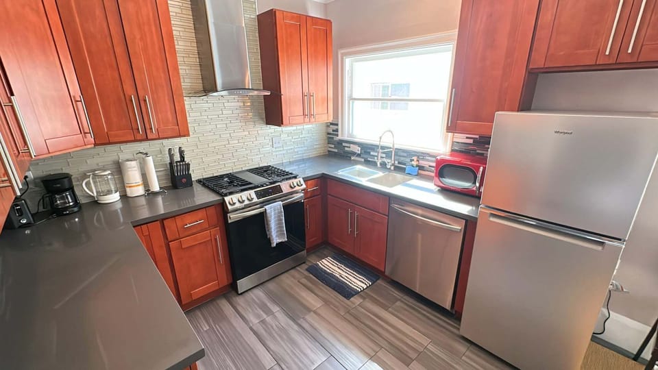 Cook with ease in a full kitchen — complete with stove, fridge, and cabinets stocked for your stay.