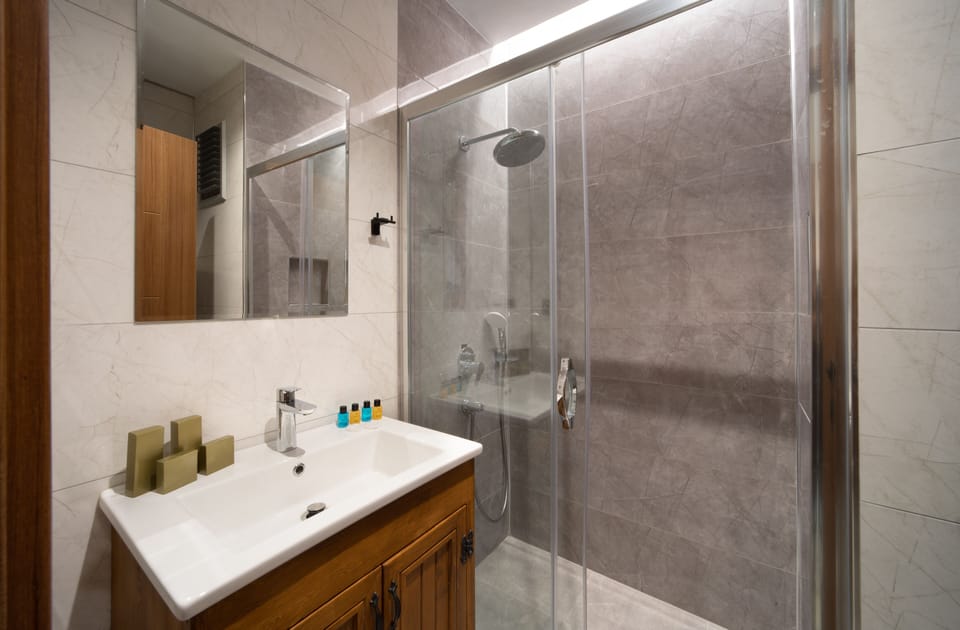 Shower, rainfall showerhead, designer toiletries, hair dryer