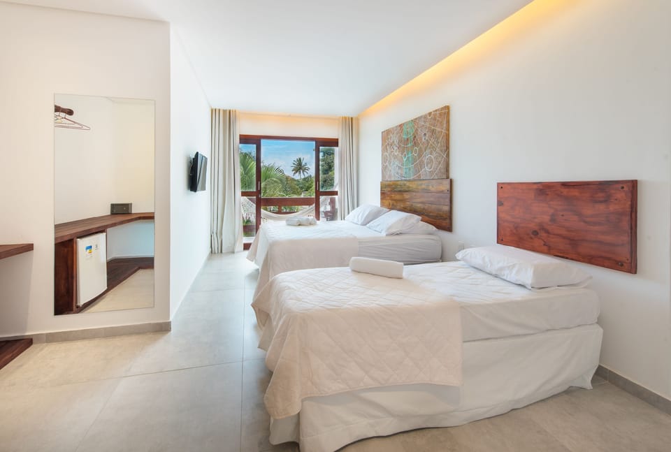 Deluxe Triple Room | Minibar, in-room safe, blackout drapes, bed sheets