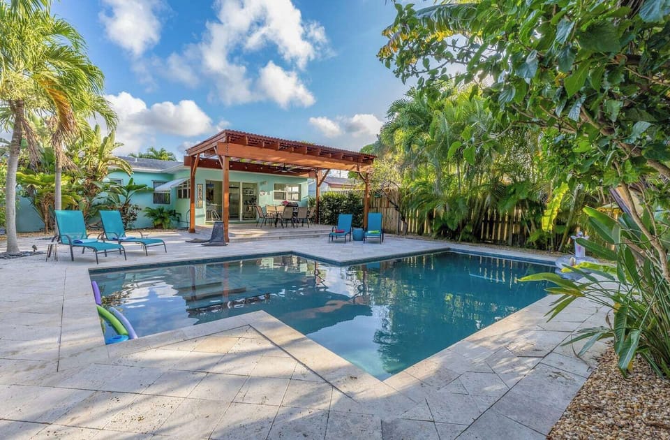 Tropical pool oasis surrounded by palms in Dania Beach