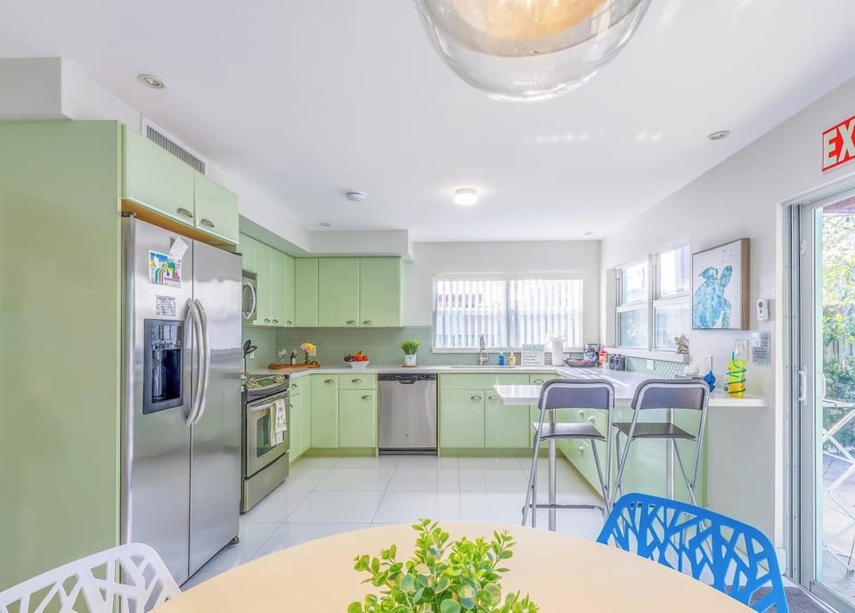 Light green kitchen with modern appliances—ideal for extended stays