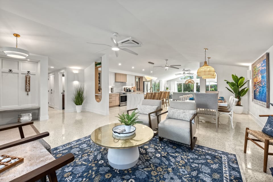 Step inside to an open, sun-filled living space where coastal tones, soft seating, and seamless flow invite you to instantly unwind.