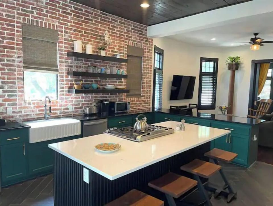 The kitchen with comfortable counter stool spots.