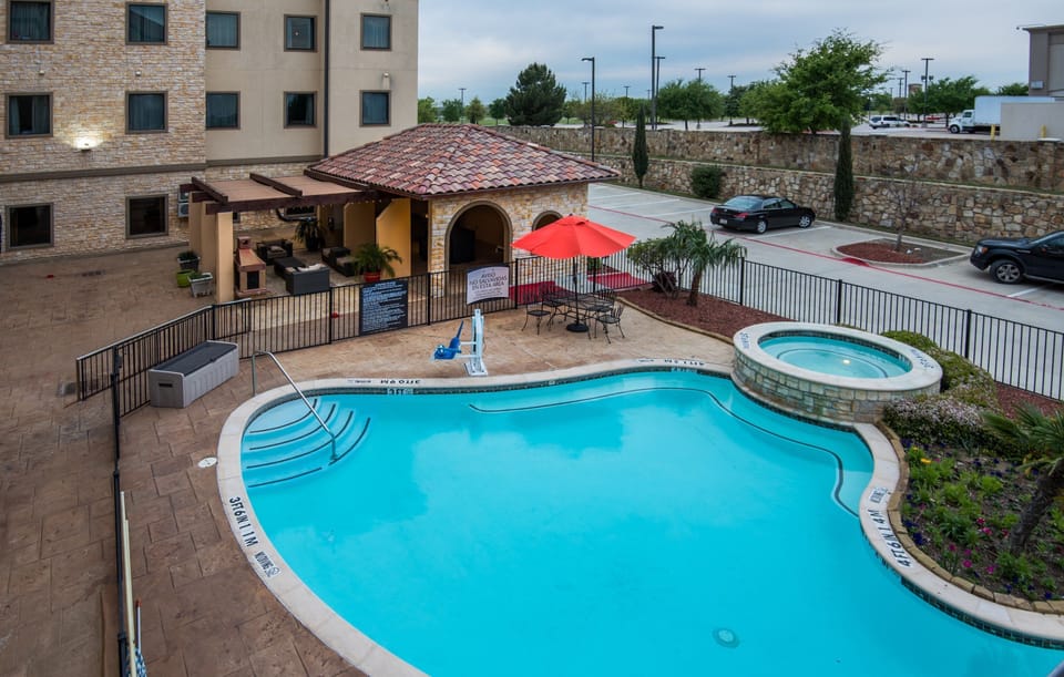 Outdoor pool with lounge chairs and umbrellas