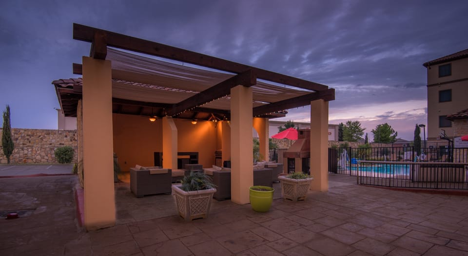 Outdoor seating area with pool view.