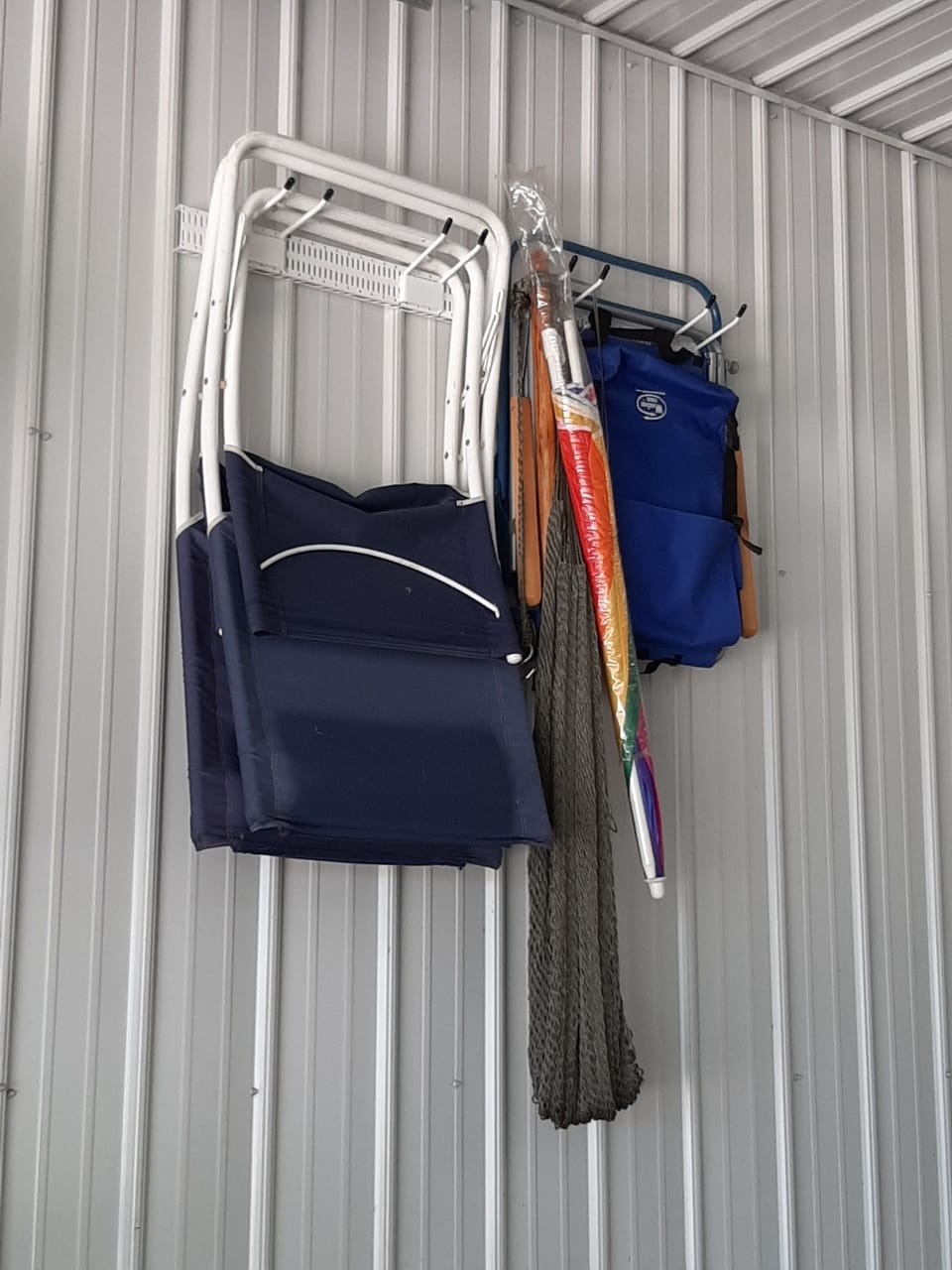 4 beach chairs for use, one umbrella