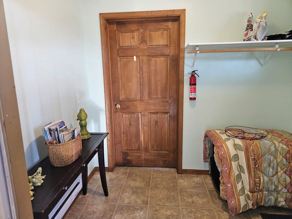 Entry way with dog kennel.