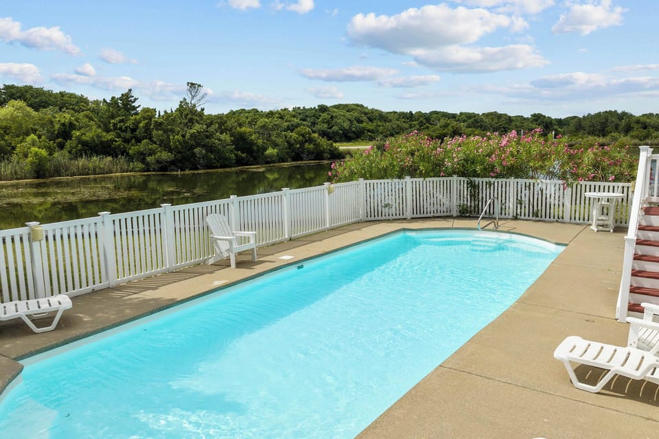 Enjoy the cross breezes that caress the large in-ground private pool as you take a swim.
