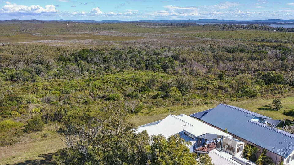Baan Sabai - Angourie accommodation with ocean views and backs onto National Park - Aerial view of property and National Park