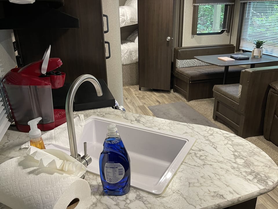 No one likes doing the dishes, but at least you can with ease in our camper.