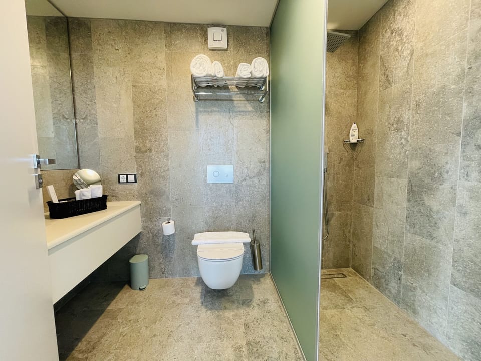 Premium Studio Suite, Balcony, City View | Bathroom | Shower, rainfall showerhead, free toiletries, hair dryer