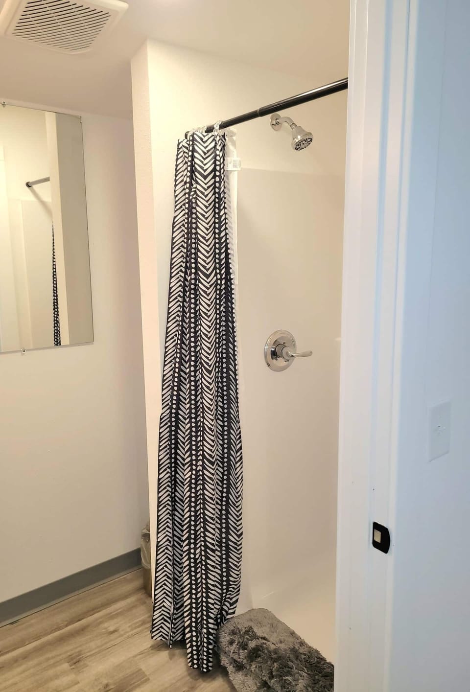 This bathroom has a standup shower, toilet and sink. It is located on the main floor. 