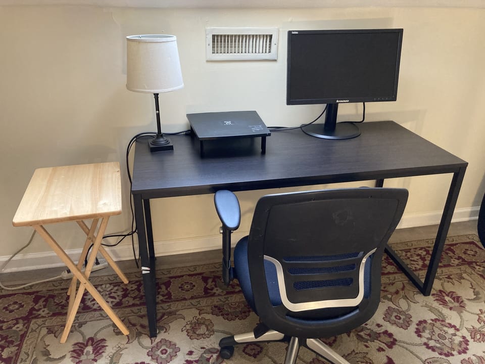 Office with a desk, comfortable office chair and a computer monitor.