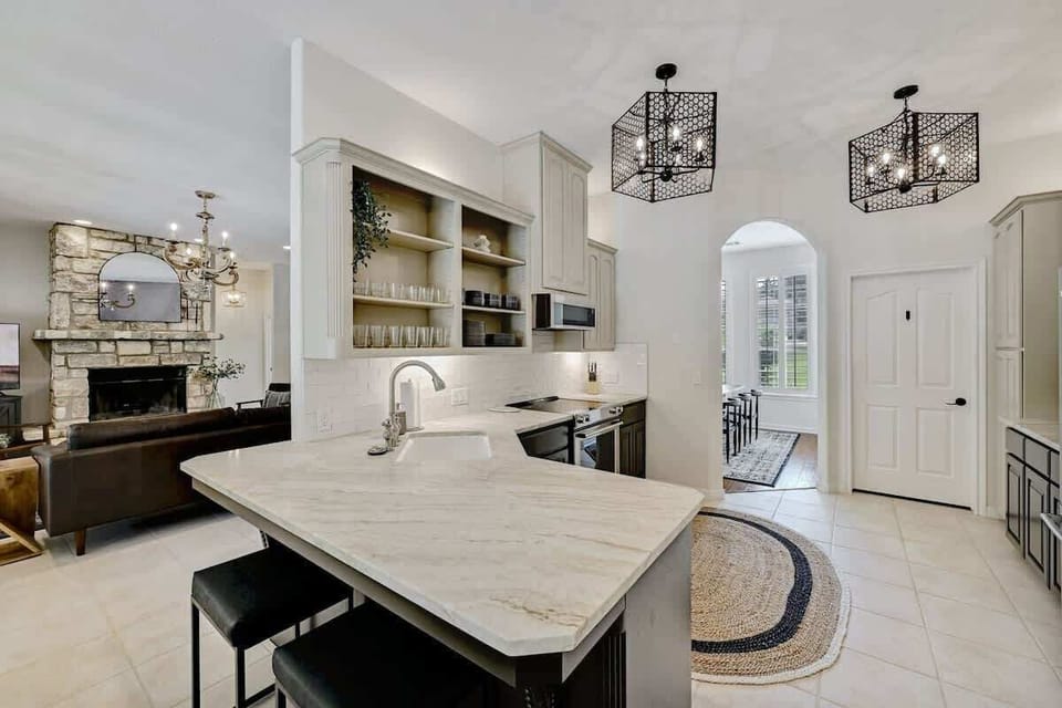 Spacious, fully-equipped kitchen with coffee maker and bar seating.