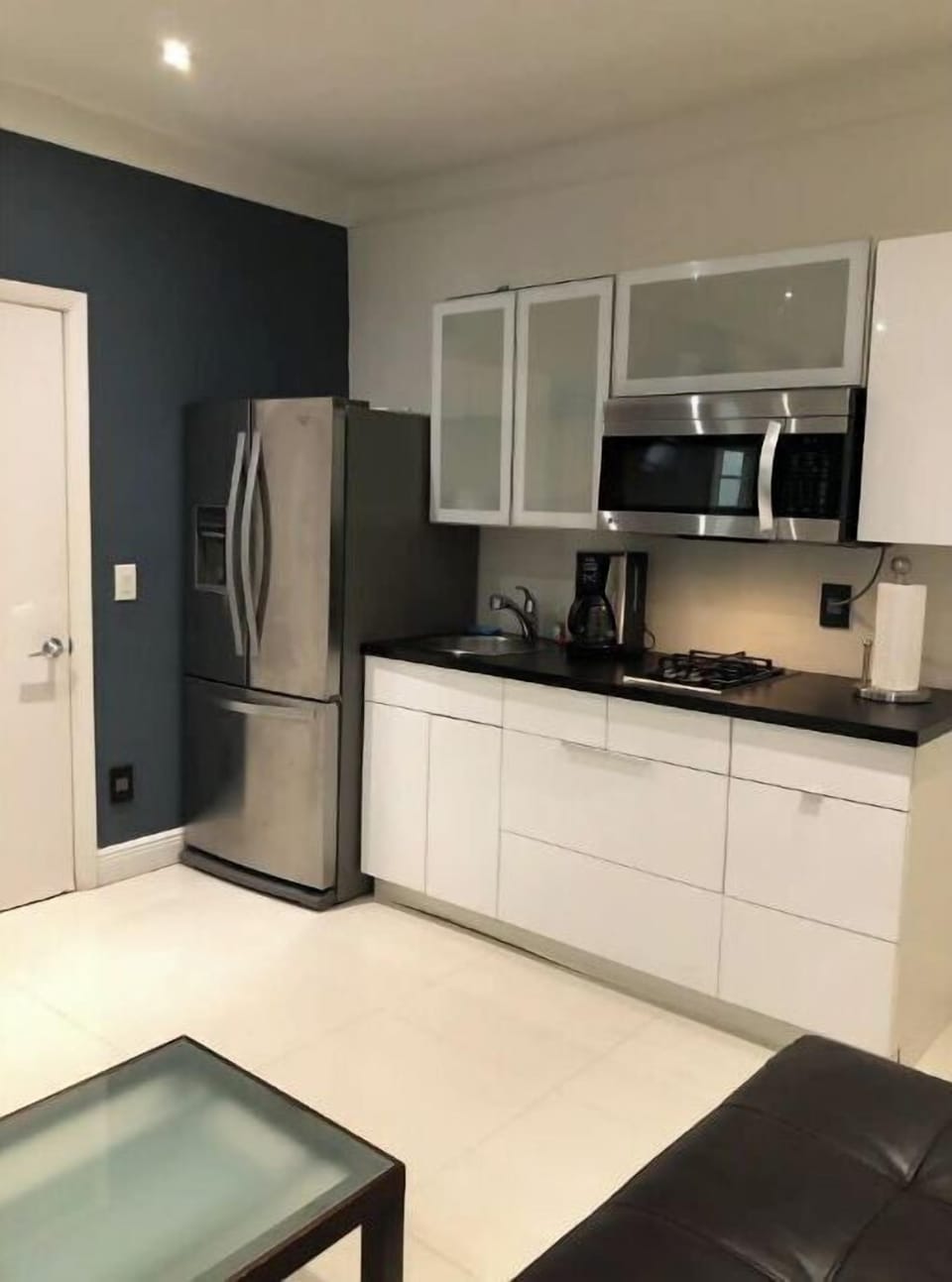Kitchen with gas stove, microwave and full size fridge