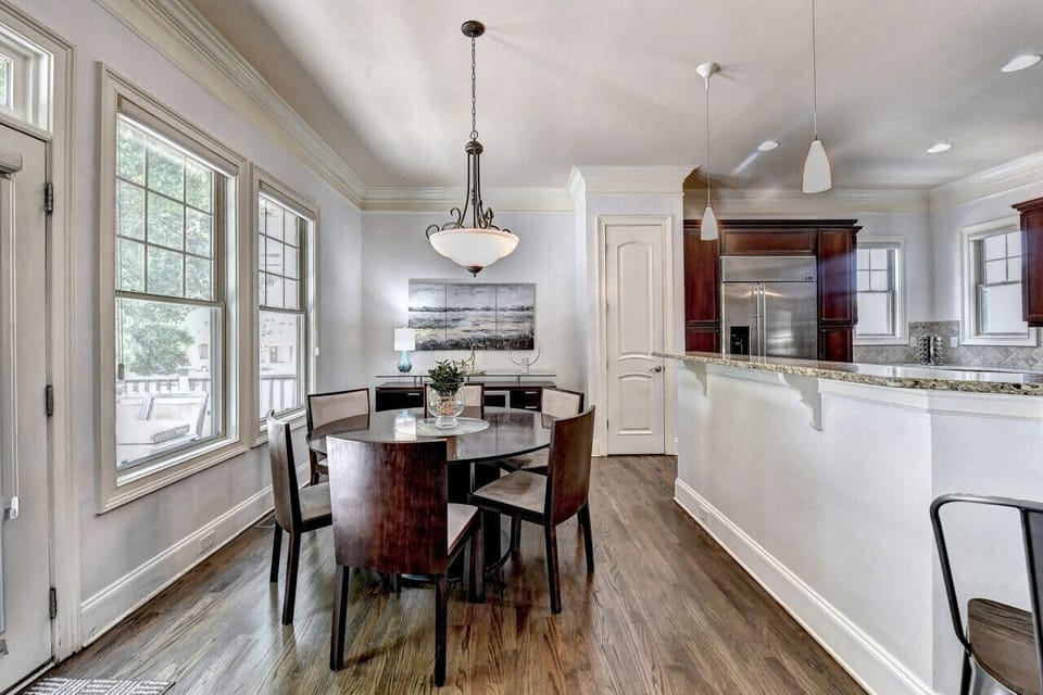 The well-equipped kitchen area boasts a stylish countertop with a sink, modern appliances including a stove and refrigerator, providing the perfect hub for culinary adventures and delightful gatherings.