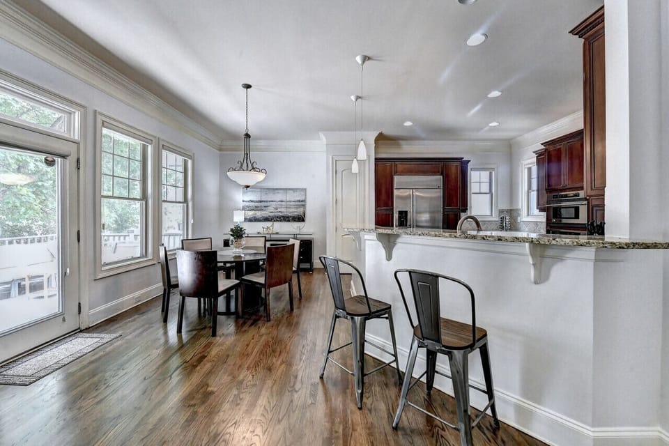 The well-equipped kitchen area boasts a stylish countertop with a sink, modern appliances including a stove and refrigerator, providing the perfect hub for culinary adventures and delightful gatherings.