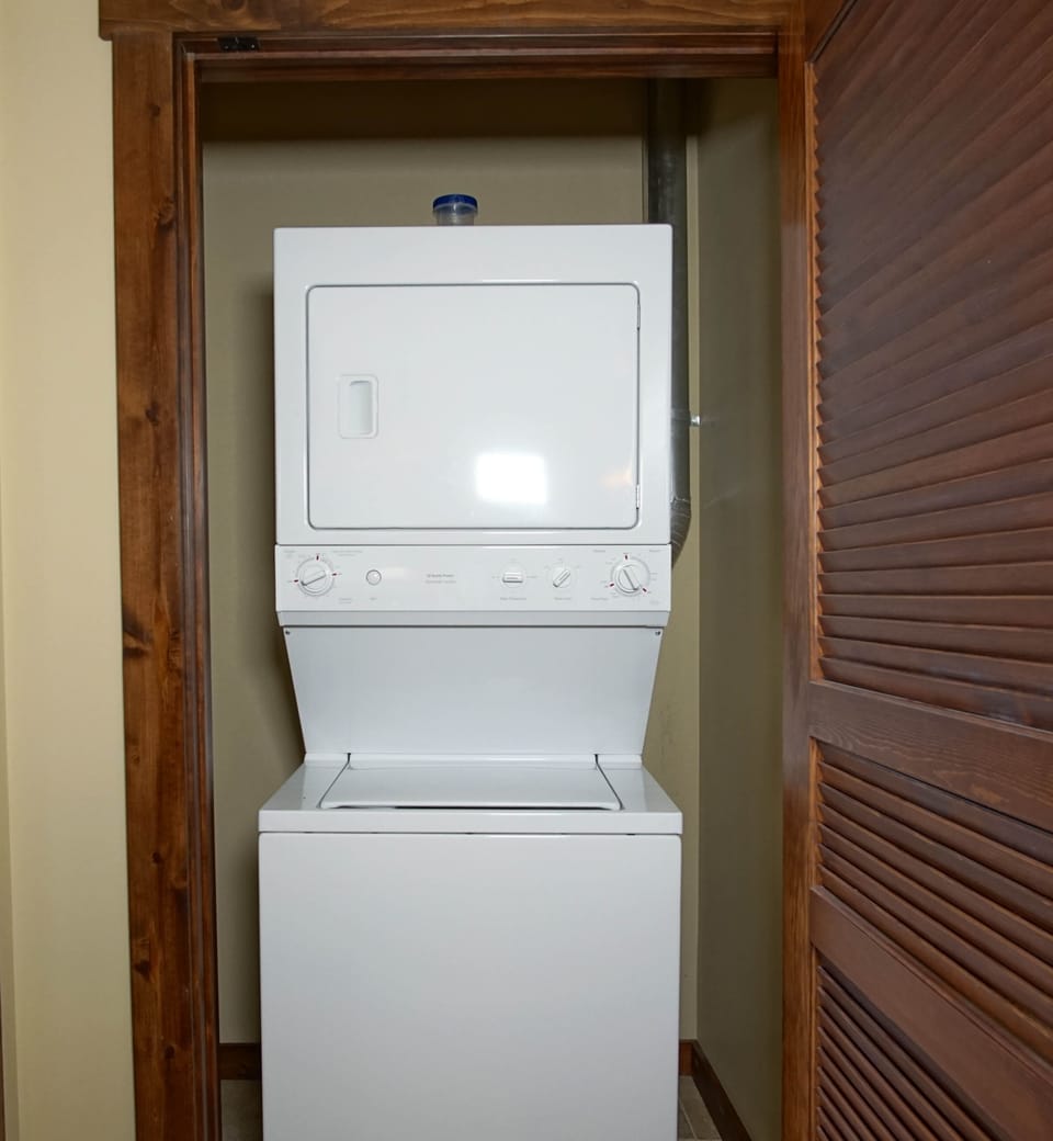 Stackable washer/dryer located in closet in the hallway between the bedrooms