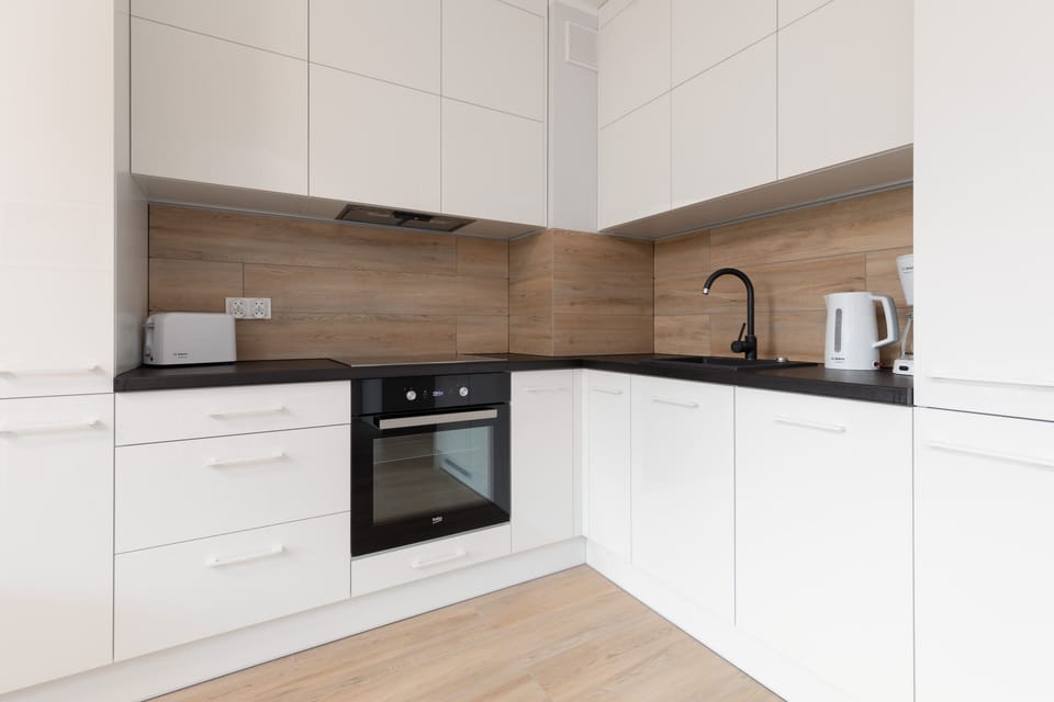 Kitchenette with oven and refrigerator. 